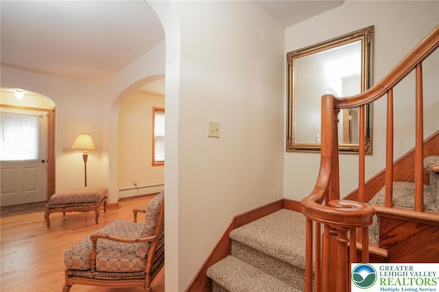 717 Claremont Ave, Schuylkill, PA 18252 - stairway featuring baseboard heating, arched walkways, and wood finished floors