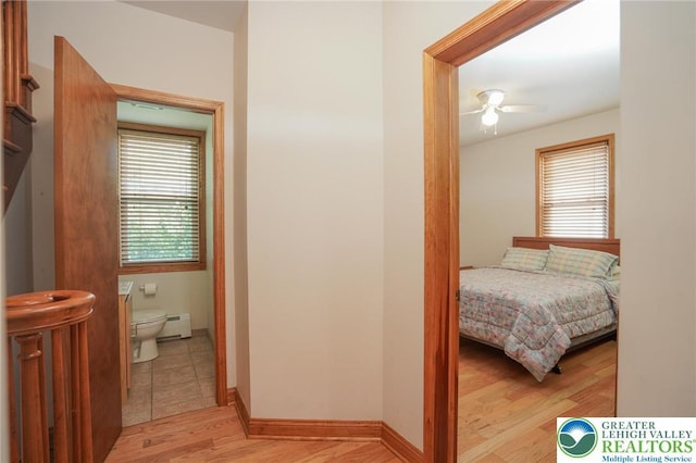 717 Claremont Ave, Schuylkill, PA 18252 - bedroom featuring a baseboard heating unit, light wood-type flooring, and a ceiling fan