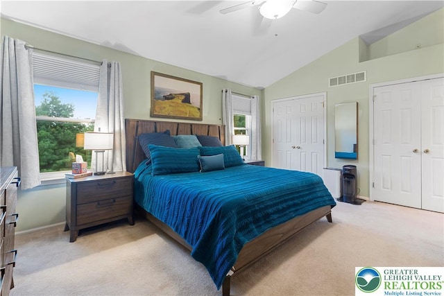 8067 Heritage Dr, Lower Macungie Twp, PA 18011 - bedroom with light colored carpet, multiple closets, lofted ceiling, and a ceiling fan