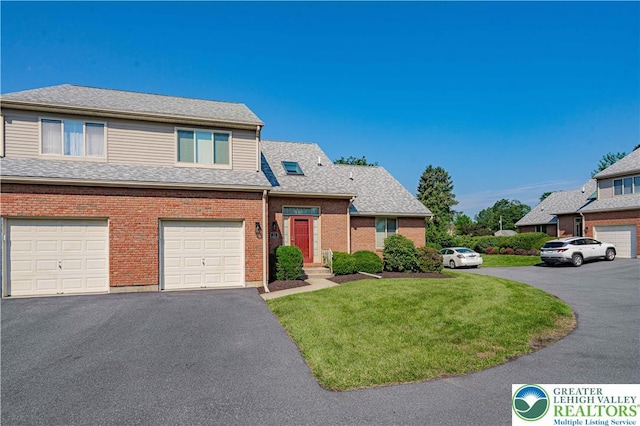 21 Winfield Ct, Easton, PA 18045 - view of front of house featuring asphalt driveway, a front yard, brick siding, an attached garage, and a shingled roof