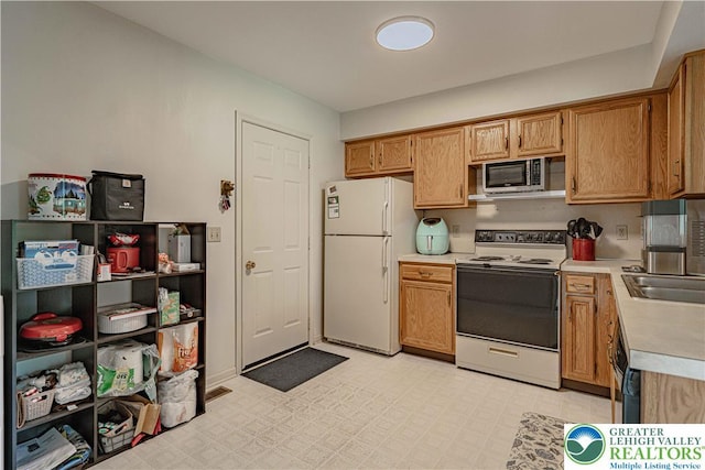 21 Winfield Ct, Easton, PA 18045 - kitchen with white appliances, light countertops, and light flooring