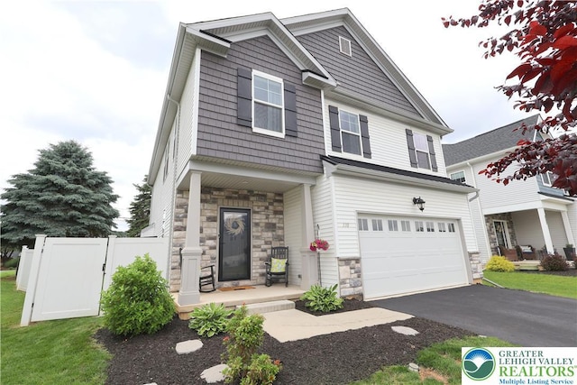 330 Bendelow Ln, Northampton Boro, PA 18067 - view of front facade with stone siding, a porch, an attached garage, and asphalt driveway
