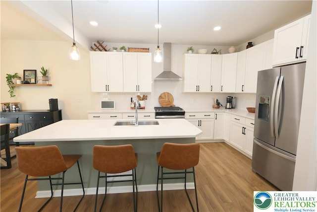 330 Bendelow Ln, Northampton Boro, PA 18067 - kitchen with stainless steel refrigerator with ice dispenser, wall chimney exhaust hood, range, a kitchen bar, and recessed lighting
