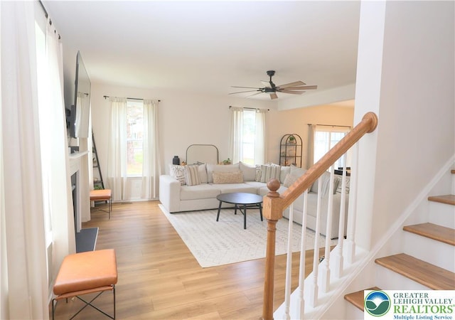 330 Bendelow Ln, Northampton Boro, PA 18067 - living room with stairway, light wood-style flooring, ceiling fan, and a fireplace