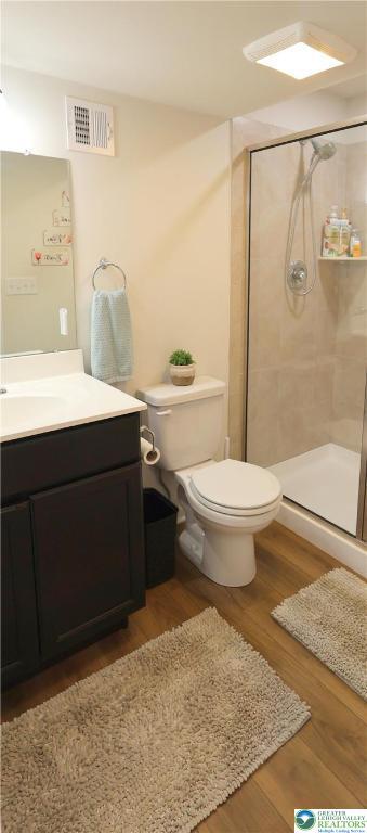 330 Bendelow Ln, Northampton Boro, PA 18067 - full bathroom featuring vanity, a shower stall, and wood finished floors