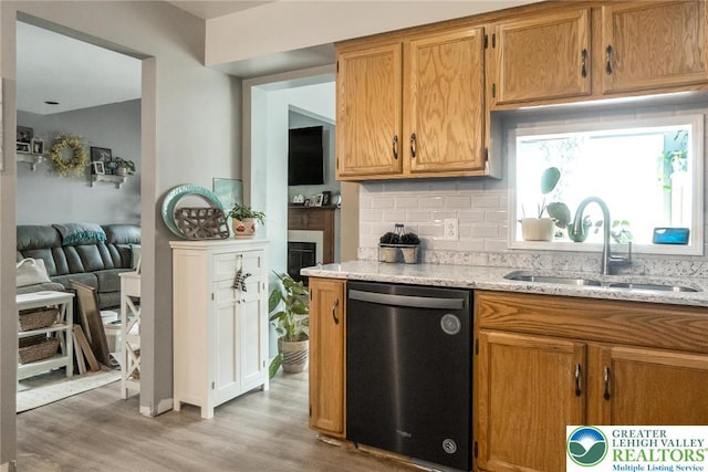 104 Stephanie Dr, Palmer Twp, PA 18045 - kitchen with dishwasher, backsplash, light wood-style flooring, light stone countertops, and brown cabinets