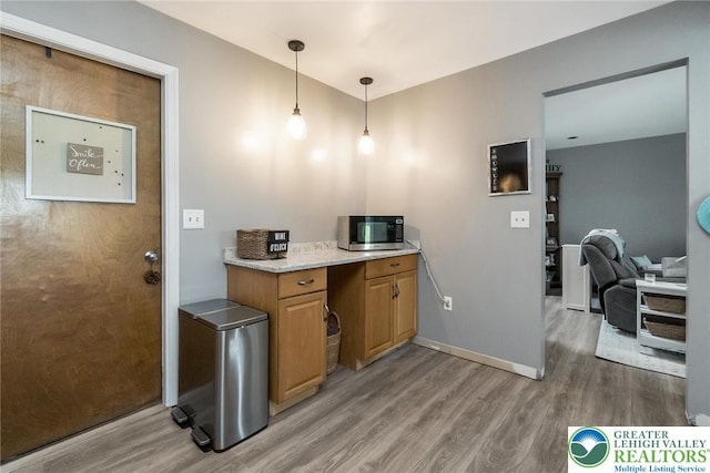 104 Stephanie Dr, Palmer Twp, PA 18045 - kitchen with light wood finished floors, brown cabinets, and decorative light fixtures