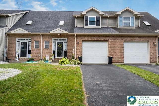 104 Stephanie Dr, Palmer Twp, PA 18045 - townhome / multi-family property featuring entry steps, a front yard, driveway, brick siding, and roof with shingles