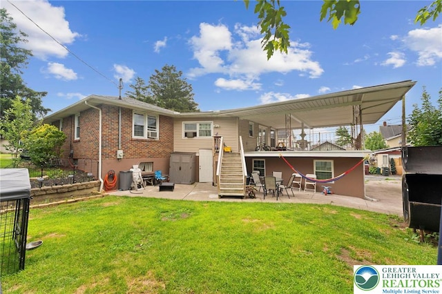 4116 Springmill Rd, Whitehall Twp, PA 18052 - rear view of property with stairway, a patio, brick siding, and a lawn