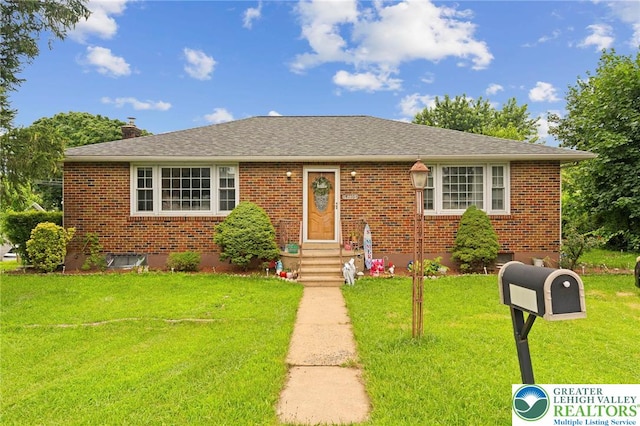 4116 Springmill Rd, Whitehall Twp, PA 18052 - bungalow with brick siding, a front yard, a chimney, and roof with shingles