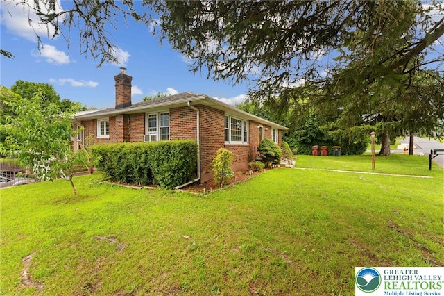 4116 Springmill Rd, Whitehall Twp, PA 18052 - view of side of home with brick siding, a chimney, and a lawn