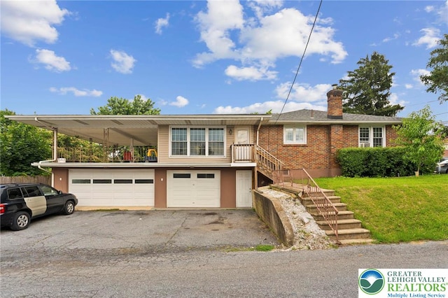 4116 Springmill Rd, Whitehall Twp, PA 18052 - view of front facade featuring an attached garage, asphalt driveway, a chimney, stairway, and brick siding