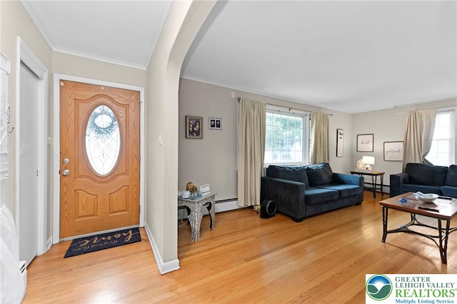 4116 Springmill Rd, Whitehall Twp, PA 18052 - entrance foyer featuring baseboard heating, arched walkways, plenty of natural light, light wood-style flooring, and crown molding