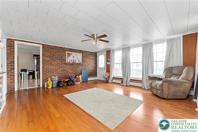 4116 Springmill Rd, Whitehall Twp, PA 18052 - living area featuring ceiling fan, wood-type flooring, brick wall, and a baseboard heating unit