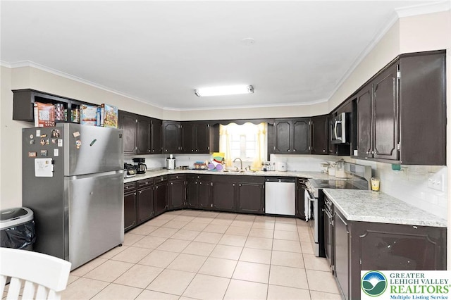 4116 Springmill Rd, Whitehall Twp, PA 18052 - kitchen with appliances with stainless steel finishes, light countertops, ornamental molding, dark brown cabinetry, and light tile patterned flooring