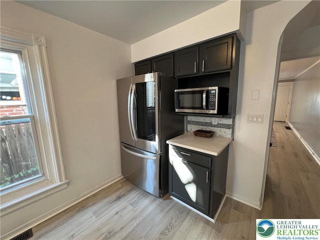 18 S Bradford St, Allentown City, PA 18109 - kitchen with appliances with stainless steel finishes, light wood-style flooring, light countertops, and arched walkways