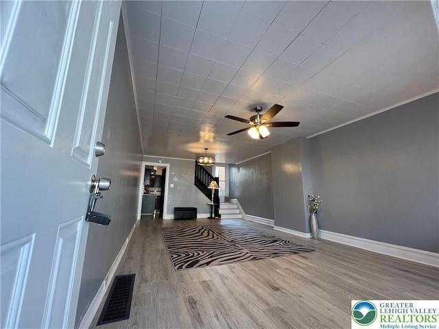18 S Bradford St, Allentown City, PA 18109 - foyer entrance with wood finished floors, stairs, and ceiling fan
