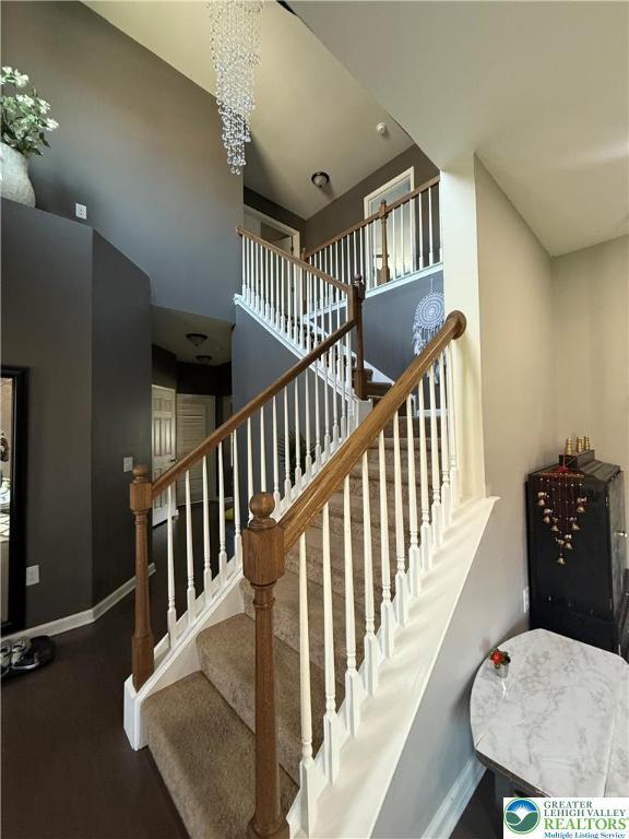 3563 Sweetgum Dr, Lower Nazareth Twp, PA 18064 - staircase with baseboards and a chandelier