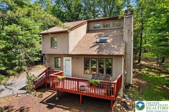 117 Manchester Dr, Lehman Twp, PA 18324 - rear view of property with a shingled roof, a deck, and a chimney