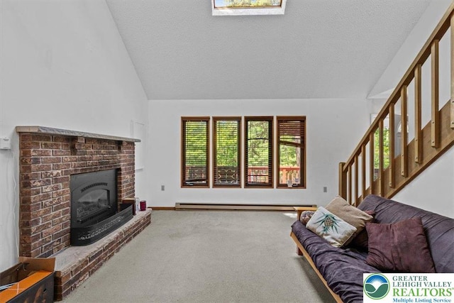 117 Manchester Dr, Lehman Twp, PA 18324 - living area with vaulted ceiling, a textured ceiling, carpet flooring, baseboard heating, and a fireplace