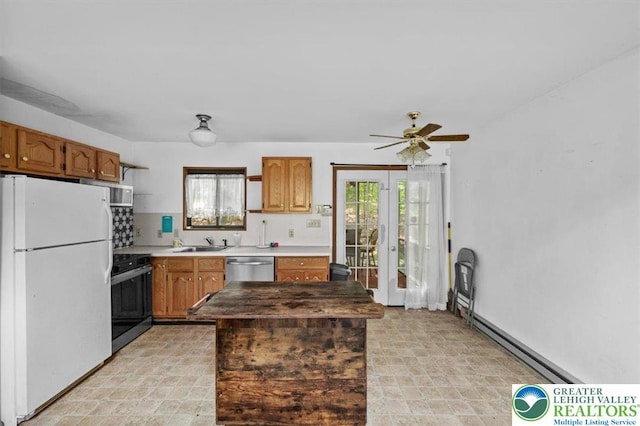 117 Manchester Dr, Lehman Twp, PA 18324 - kitchen with appliances with stainless steel finishes, ceiling fan, baseboard heating, and brown cabinets