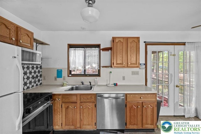 117 Manchester Dr, Lehman Twp, PA 18324 - kitchen featuring stainless steel appliances, light countertops, brown cabinets, and french doors