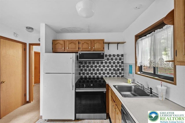 117 Manchester Dr, Lehman Twp, PA 18324 - kitchen with stainless steel appliances, light countertops, tasteful backsplash, open shelves, and brown cabinets