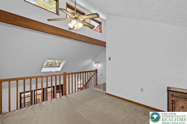 117 Manchester Dr, Lehman Twp, PA 18324 - carpeted empty room with lofted ceiling, a skylight, ceiling fan, and a textured ceiling