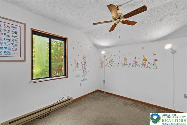117 Manchester Dr, Lehman Twp, PA 18324 - spare room featuring a baseboard heating unit, carpet floors, vaulted ceiling, a textured ceiling, and a ceiling fan