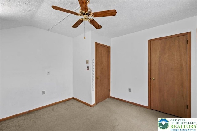 117 Manchester Dr, Lehman Twp, PA 18324 - unfurnished bedroom with a textured ceiling, carpet, ceiling fan, and vaulted ceiling