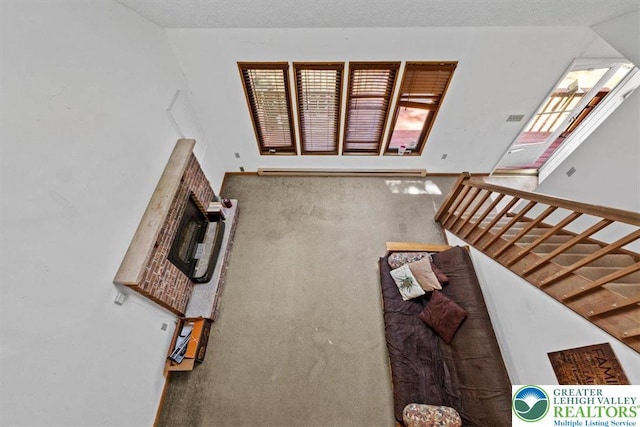 117 Manchester Dr, Lehman Twp, PA 18324 - living area with baseboard heating, stairway, carpet flooring, and healthy amount of natural light