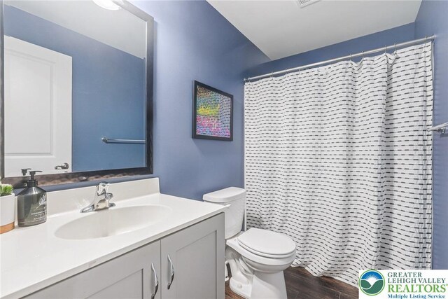 3334 Coventry Dr, Lower Macungie Twp, PA 18062 - full bathroom featuring vanity, wood finished floors, and a shower with curtain