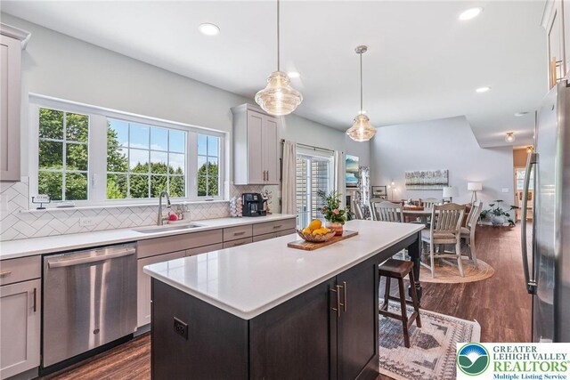 3334 Coventry Dr, Lower Macungie Twp, PA 18062 - kitchen with appliances with stainless steel finishes, light countertops, tasteful backsplash, a kitchen island, and recessed lighting
