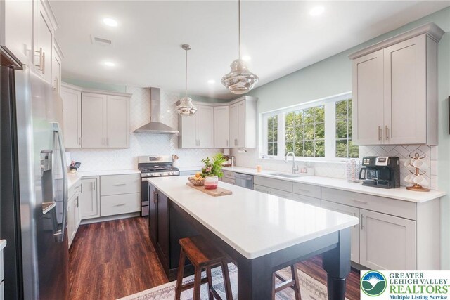 3334 Coventry Dr, Lower Macungie Twp, PA 18062 - kitchen with stainless steel appliances, wall chimney range hood, backsplash, dark wood-style flooring, and recessed lighting