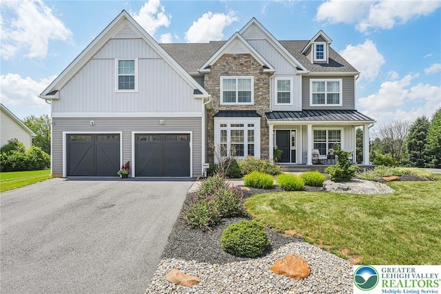 3334 Coventry Dr, Lower Macungie Twp, PA 18062 - view of front of property with a porch, asphalt driveway, a garage, a front yard, and a standing seam roof