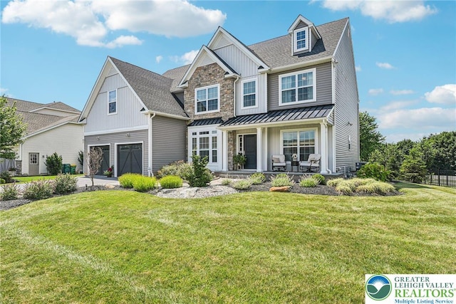 3334 Coventry Dr, Lower Macungie Twp, PA 18062 - view of front of home with board and batten siding, an attached garage, a standing seam roof, and a front lawn
