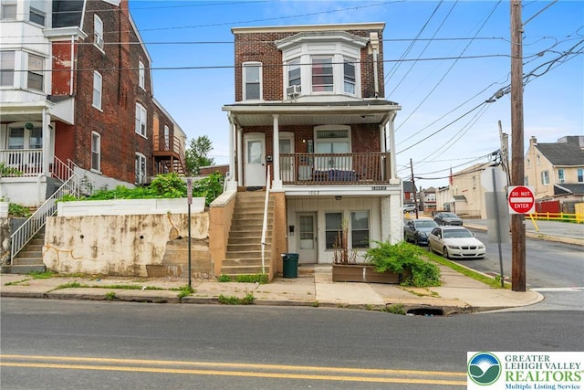 1002 S 6th St, Allentown City, PA 18103 - townhome / multi-family property with stairs, brick siding, and a porch