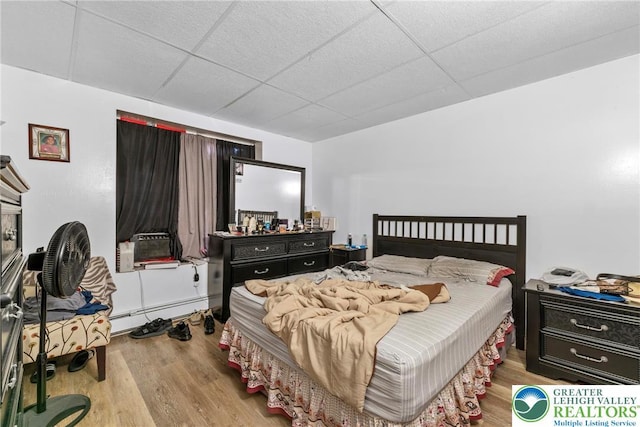 1002 S 6th St, Allentown City, PA 18103 - bedroom with a paneled ceiling, a baseboard radiator, wood finished floors, and cooling unit