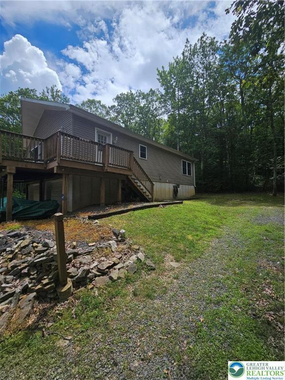 178 Sparrow Ln, Penn Forest Twp, PA 18229 - rear view of property with a wooden deck, stairway, and a lawn