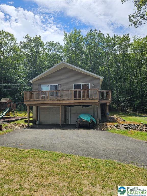 178 Sparrow Ln, Penn Forest Twp, PA 18229 - chalet / cabin with a garage, driveway, and a deck