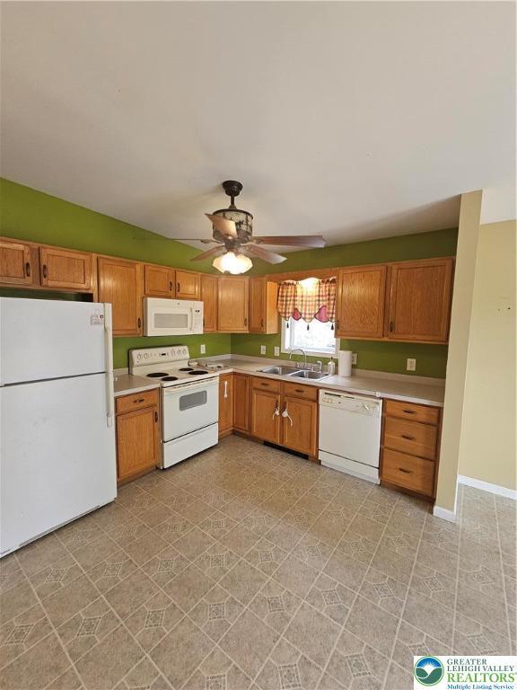 178 Sparrow Ln, Penn Forest Twp, PA 18229 - kitchen featuring white appliances, ceiling fan, light countertops, and brown cabinets