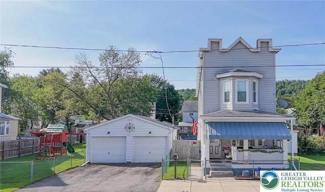 126 W High St, Coaldale Boro, PA 18218 - view of front of home with a detached garage, an outdoor structure, a fenced front yard, and a playground