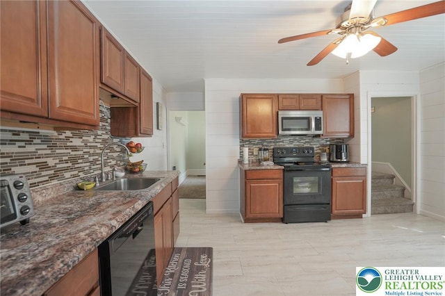 126 W High St, Coaldale Boro, PA 18218 - kitchen featuring black appliances, decorative backsplash, brown cabinetry, a ceiling fan, and dark stone counters