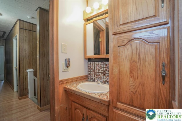 126 W High St, Coaldale Boro, PA 18218 - bathroom featuring wooden walls, vanity, wood finished floors, and wainscoting