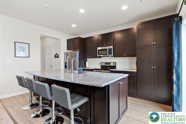 4435 Benjamin Ct, Upper Milford Twp, PA 18049 - kitchen with stainless steel appliances, light wood-style flooring, a kitchen breakfast bar, and recessed lighting