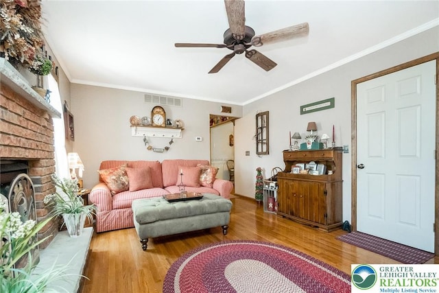 2300 Woodridge Ter, Easton, PA 18045 - living area featuring a ceiling fan, wood finished floors, crown molding, and a brick fireplace