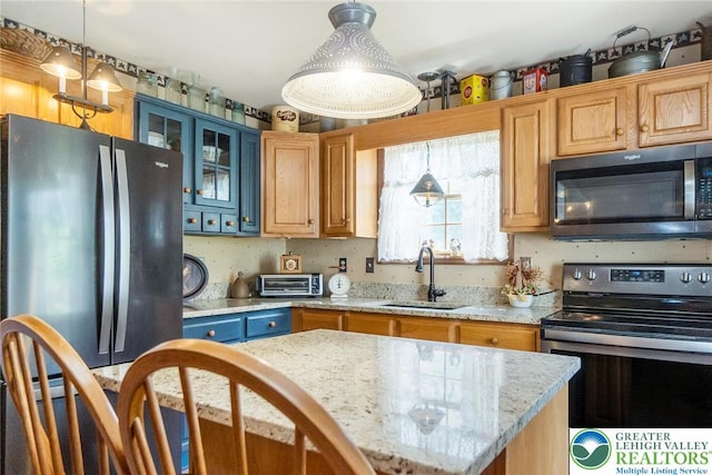 2300 Woodridge Ter, Easton, PA 18045 - kitchen with stainless steel appliances, glass insert cabinets, decorative light fixtures, light stone countertops, and a center island