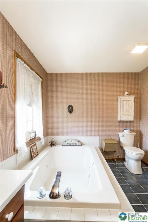 2300 Woodridge Ter, Easton, PA 18045 - full bathroom featuring a whirlpool tub, vanity, and tile patterned flooring