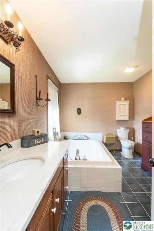 2300 Woodridge Ter, Easton, PA 18045 - full bathroom featuring vanity, a bath, tile patterned flooring, and wallpapered walls