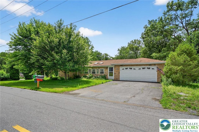 4157 Butternut Dr, Lehigh Twp, PA 18088 - view of front facade with a garage, asphalt driveway, and a front yard